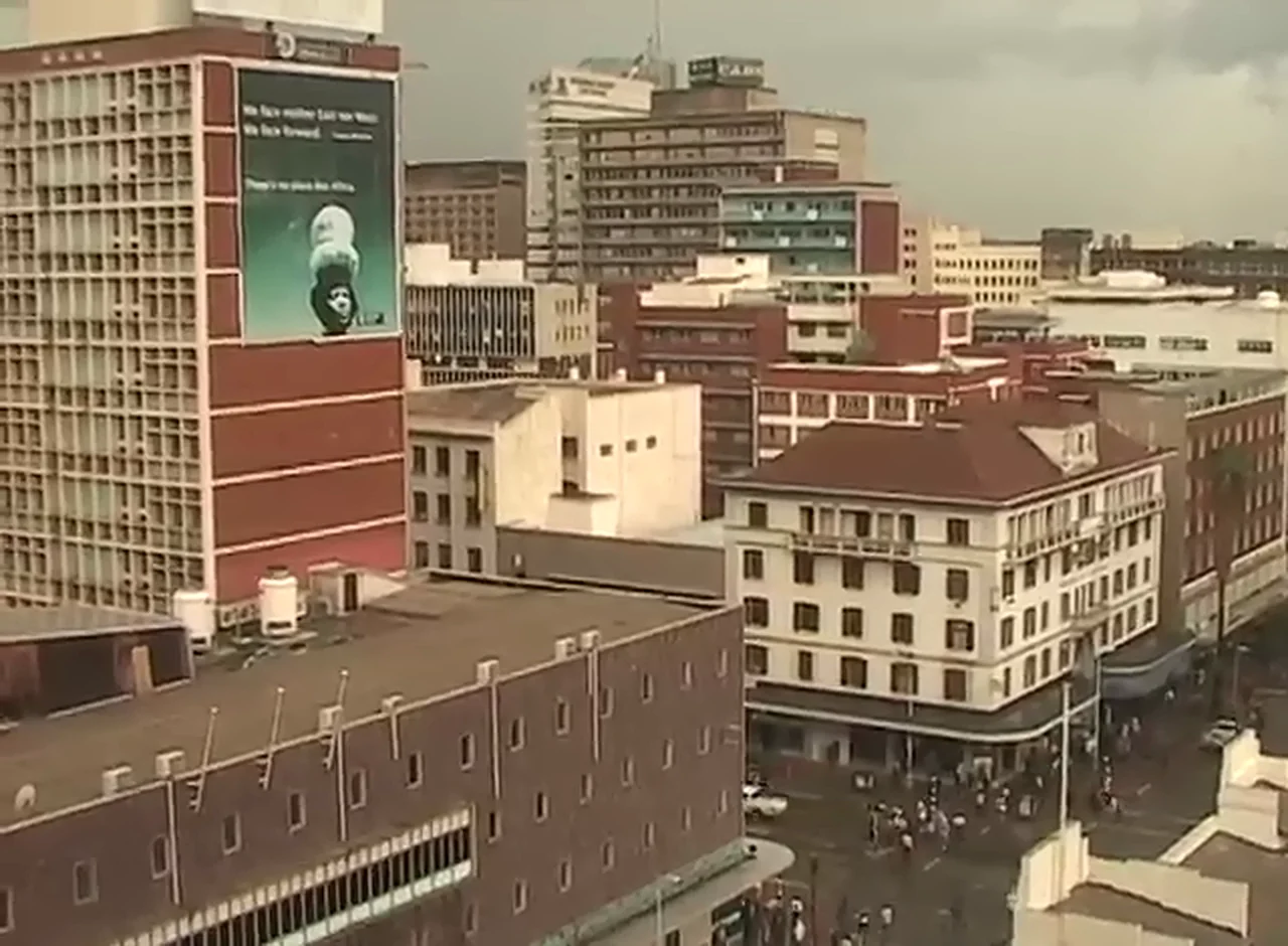 The Harare skyline in 2005, a painted portrait mural on the side of a tower block